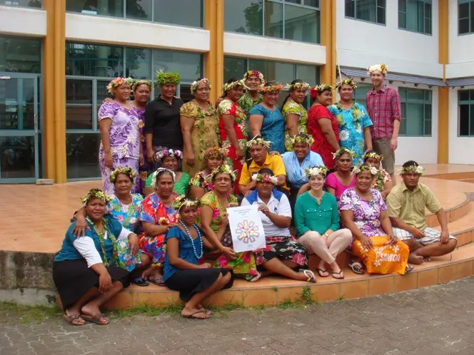 Workshop participants gathered together, wearing traditional headwear on International Archives Day.