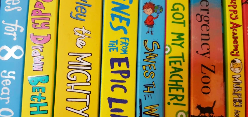 Colourful spine labels on books.