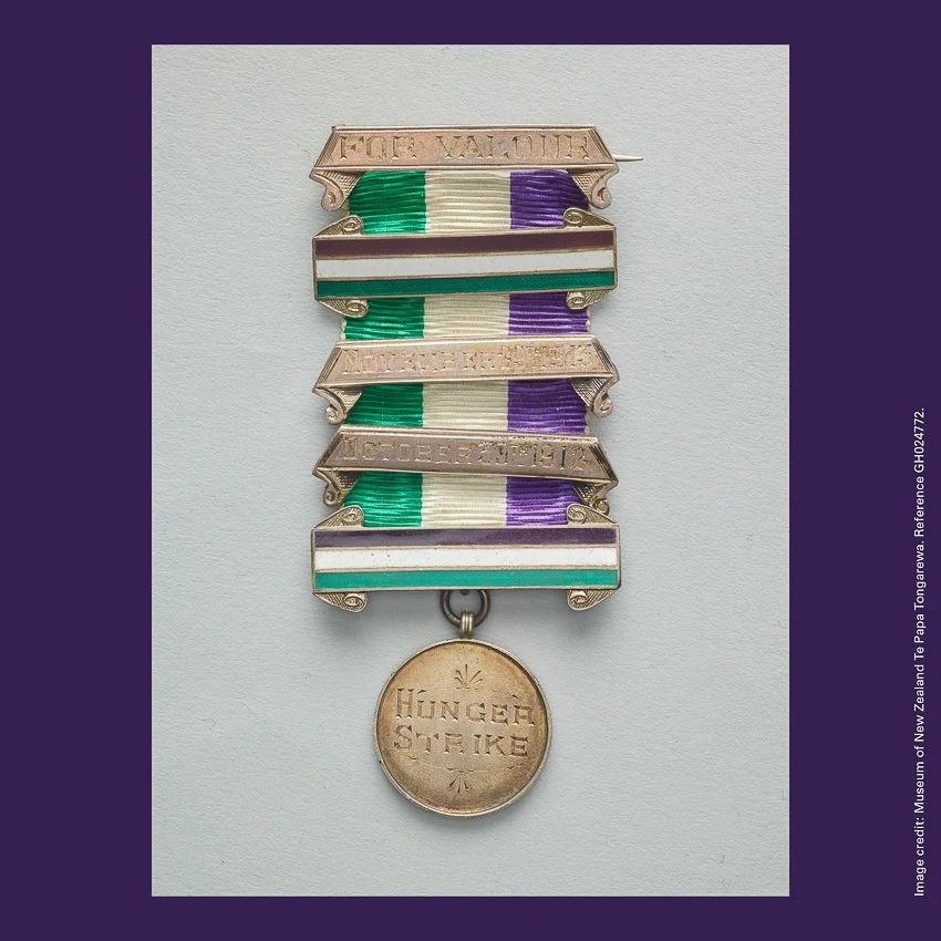 Front of curiosity card CC0014, with an image of a purple, white and green ribboned Medal For Valour awarded to Frances Parker. Medal reads 'HUNGER STRIKE'
