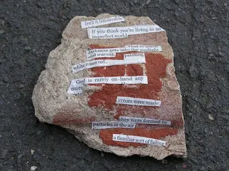 Random bits of text from different articles cut out and stuck too a rock. This is known as 'Recycled poetry'