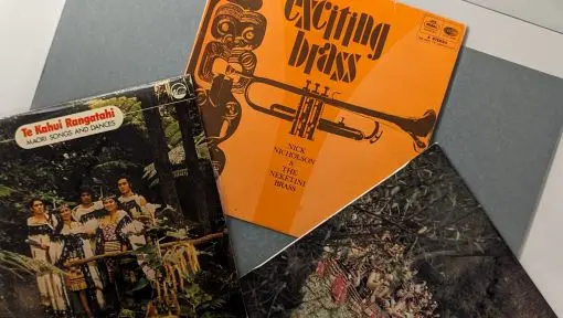A selection of three LPs laid on a table in a fan shape.