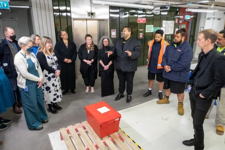 People gathered around a red box.