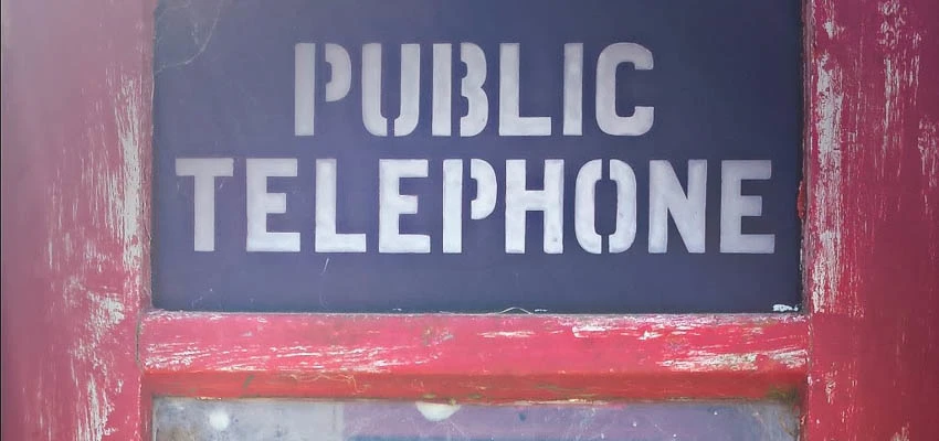 Red phone box with the words 'Public Telephone'