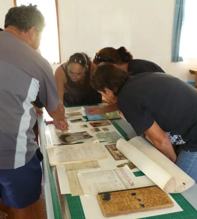 Andrew, Karen, Anne, and Dianne examining whānau items as part of the workshop.