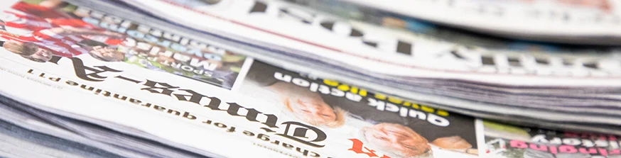 Newspapers on a table.