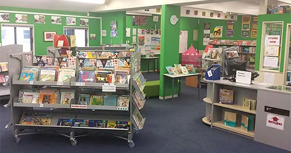 Inside a school library with books on display.