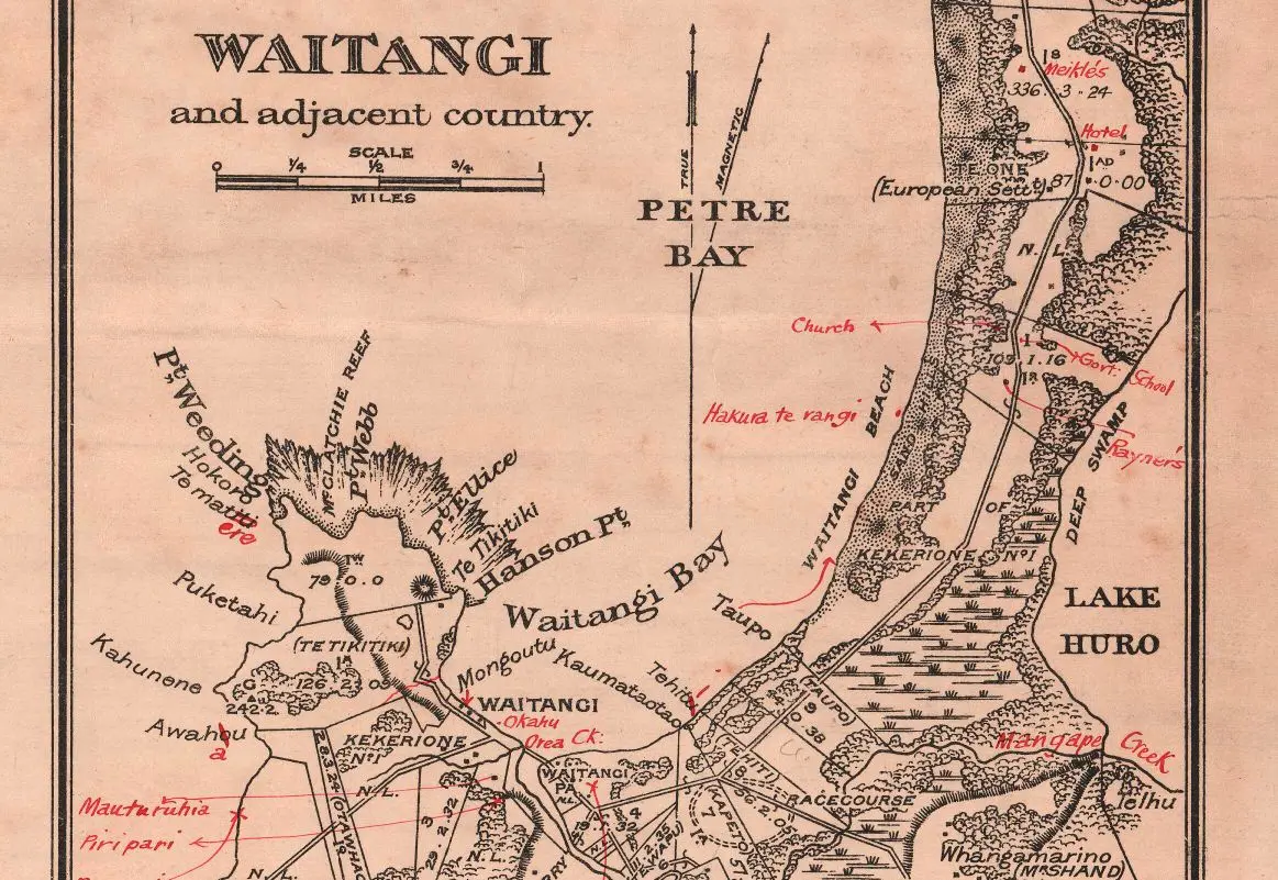 A close-up of an historic map showing the Waitangi area of the Chatham Islands, including Māori names added to locations in handwritten red ink. 