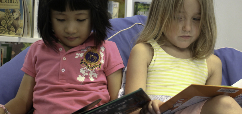 Girls reading in the library during summer.