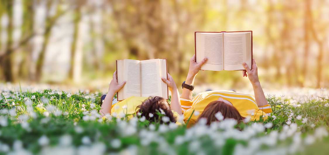 Two persons reading two books