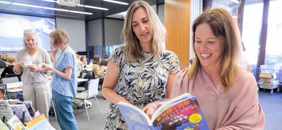 Teachers and school librarians at a Services to Schools learning event looking at books available through National Library's school lending service.