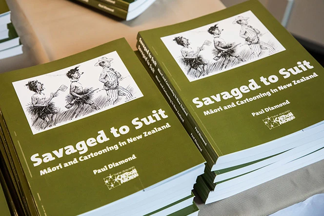 Copies of Savaged To Suit Book in a pile.