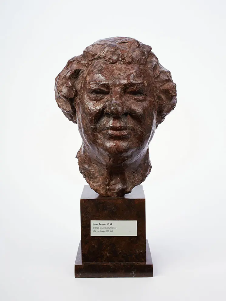 Bronze sculpture of a woman's head.
