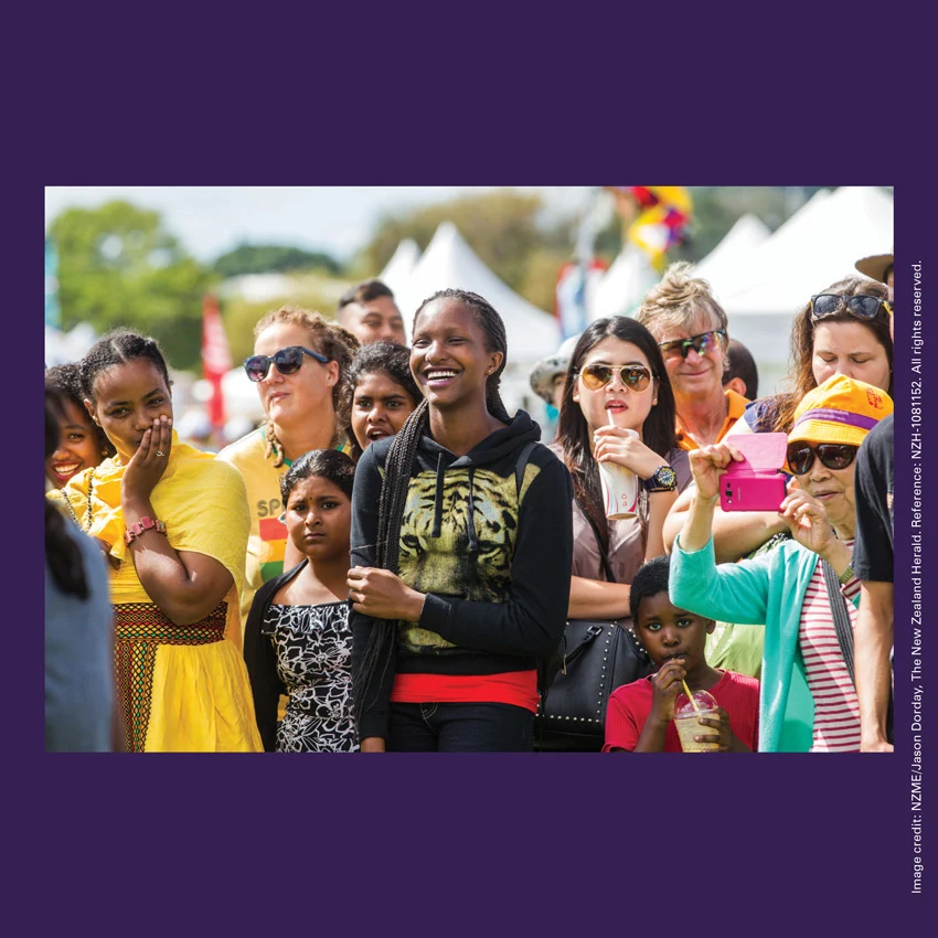 Front of curiosity card TMCC17 with an image of a multicultural crowd watching a performance