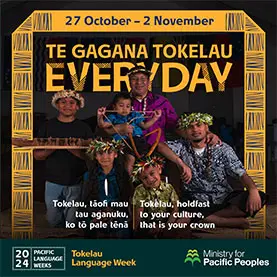 A group of people, two adult men and 4 children. They are wearing colourful shirts with pacific pattern on them and holding items of value to them and their culture. 