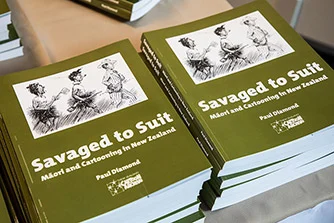 Two piles of the book 'Savaged to Suit' by Paul Diamond.