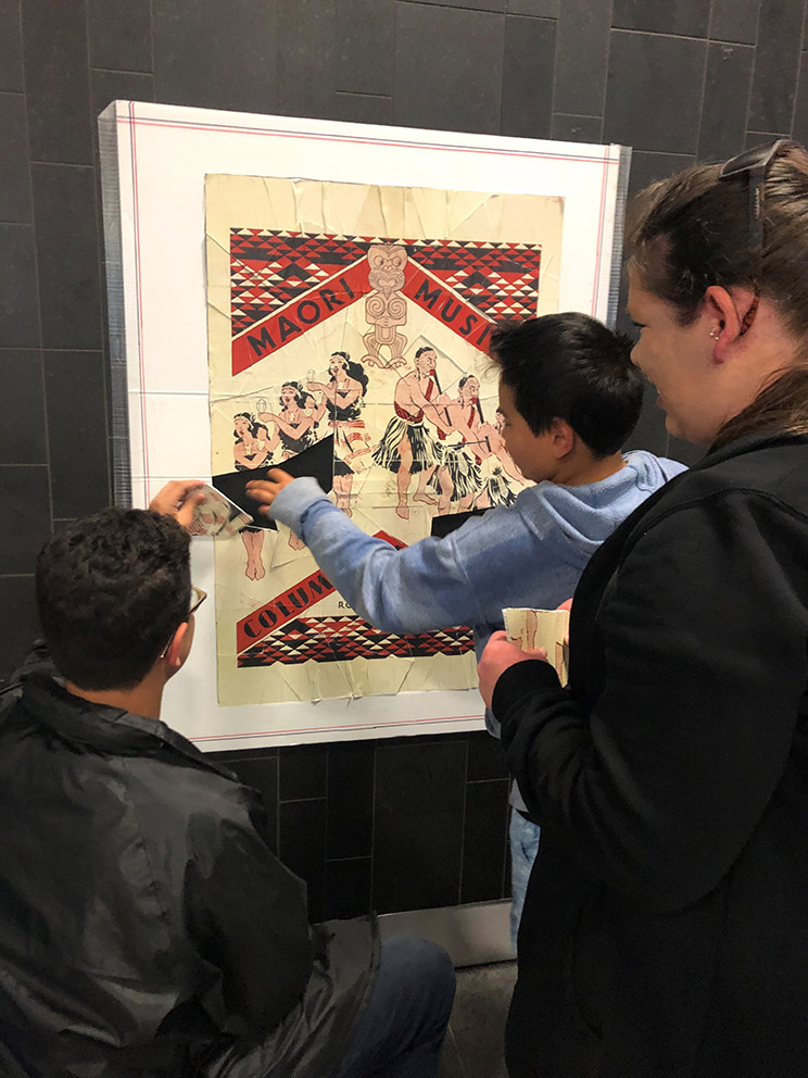 Children having fun doing a puzzle of a promotional poster.