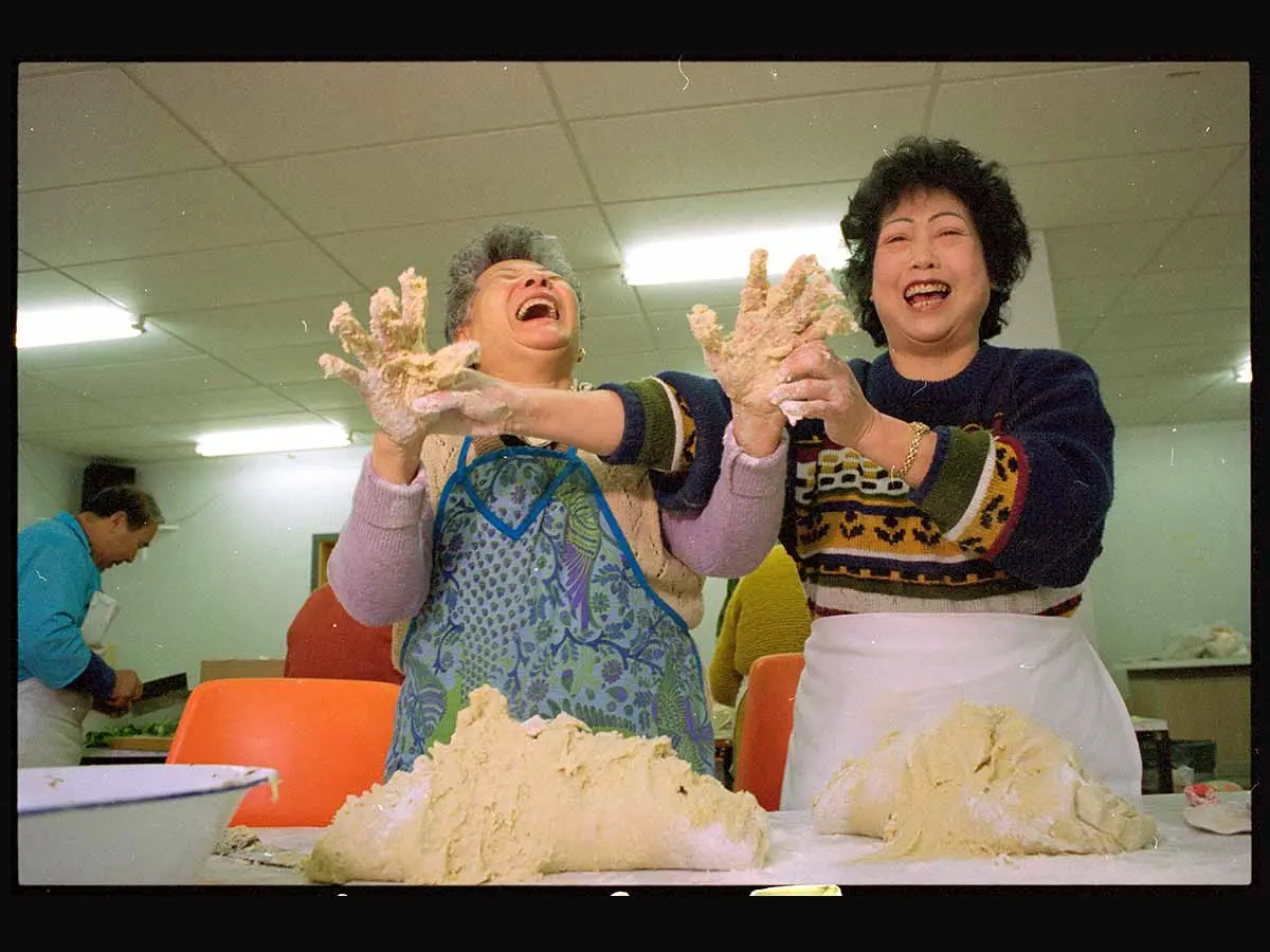 Ng Soon Yee (left) and Mel Jean Chin having a laugh while preparing red bean dumplings for the Anglican Chinese bazaar in Wellington.