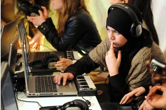 Girls at workshop learning about The Technology Behind Digital Music.