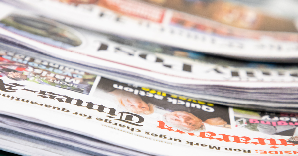 Newspapers on a table.