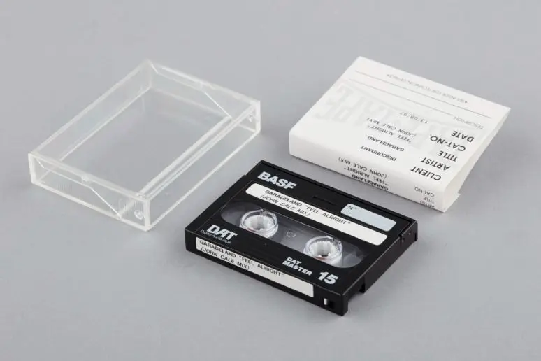 An image of a DAT that includes the plastic cover and paper insert that shows information about the contents of the tape. 