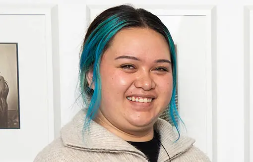 Young Māori woman smiling at the camera. 