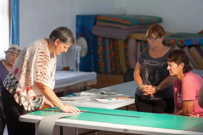 Vicki-Anne demonstrating making a four-flap folder with Karen Tahana and Dianne Kendall.