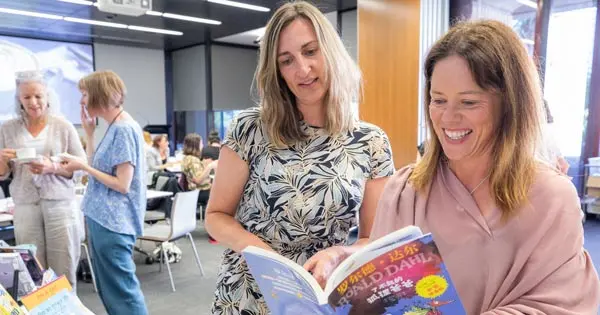 Teachers and school librarians at a Services to Schools learning event looking at books available through National Library's school lending service.