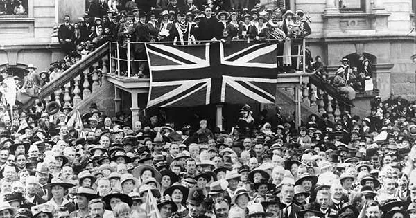 Armistice Day crowd celebrating in Dunedin with Union Jack flag.