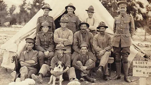 New Zealand WW1 soldiers and a dog in front of a tent.