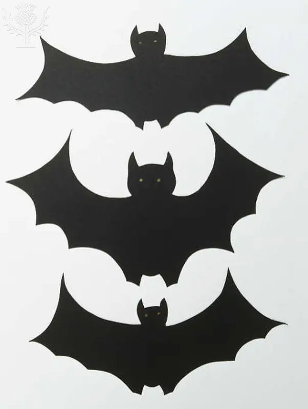 Cut out paper vampire bats.