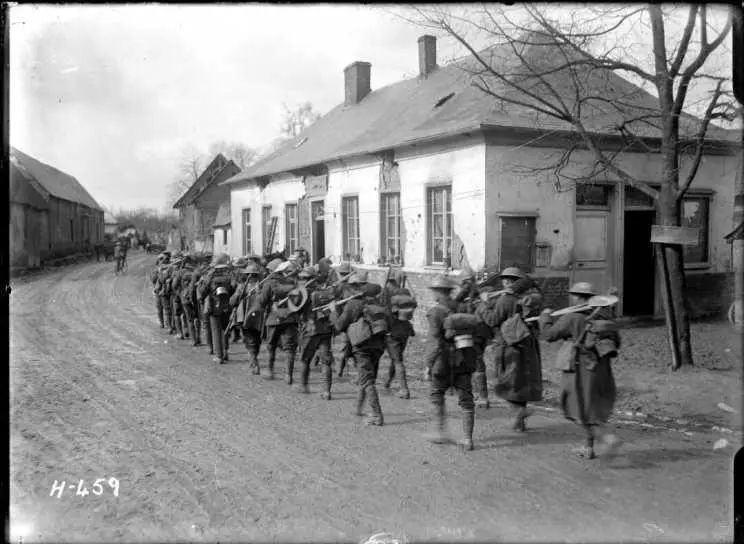 A New Zealand working party walking through Courcelles, France, World War I.