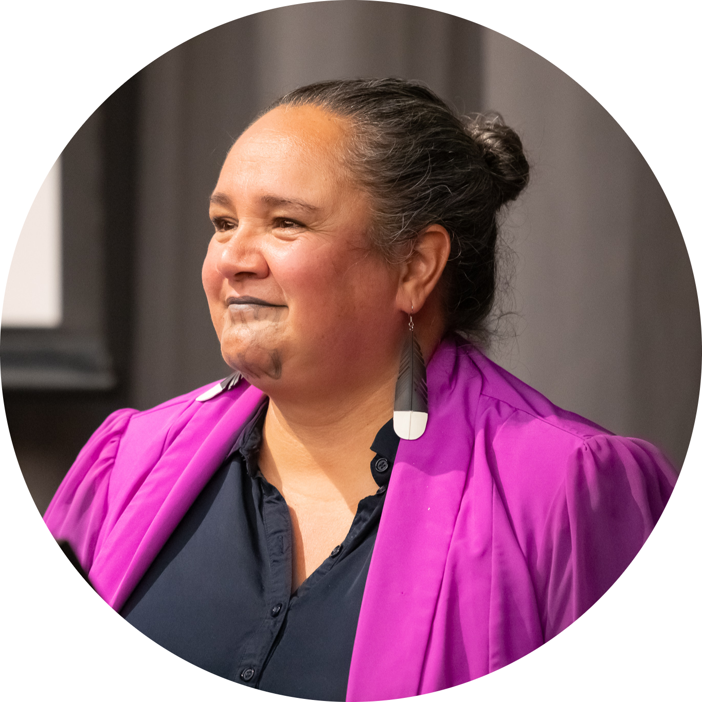 A portrait of a smiling Māori woman.