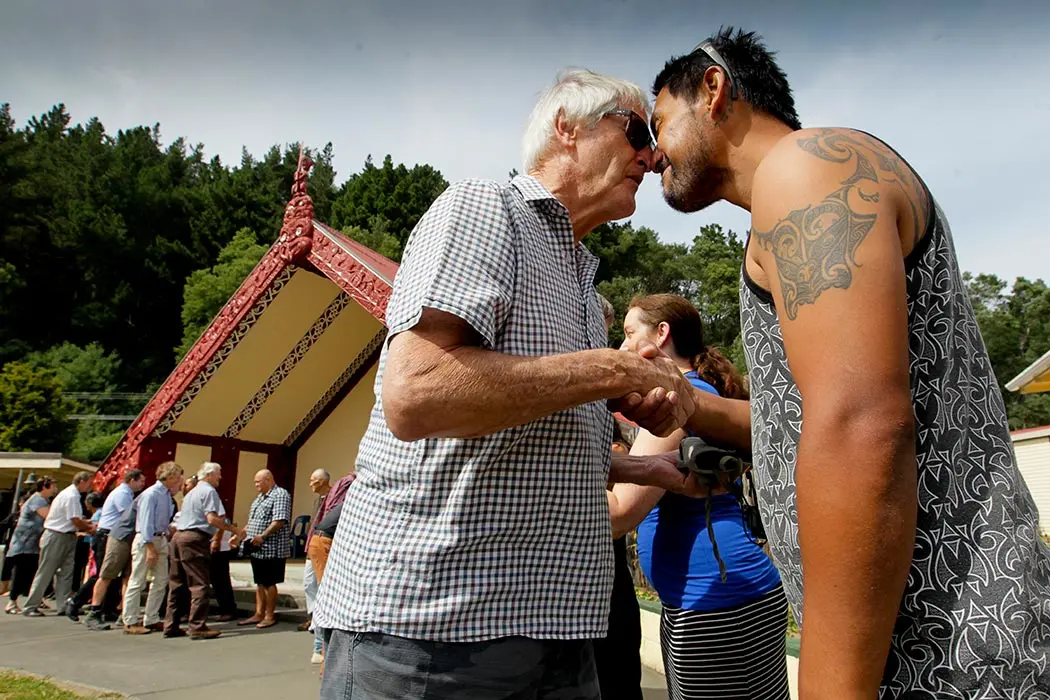 Colour photograph of Rangitane Parsons greeting Pat Parsons with a hongi at Tangoio Marae.