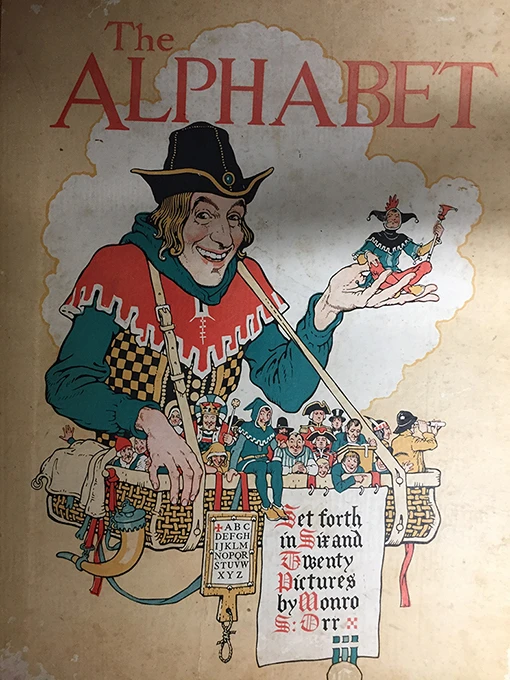 Book cover of 'The Alphabet' with an illustration of a large man carrying a group of tiny people in a basket.