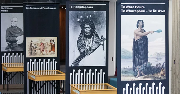 Four hanging banners showing portraits of Sir William Martin, Ereōnora and Panakareao, Te Rangitopeora, and Te Ware Pouri / Te Wharepōuri - Te Āti Awa.