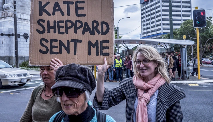 3 women in the 2017 Wellington Women's March, holding up a sign that says 'Kate Sheppard sent me'