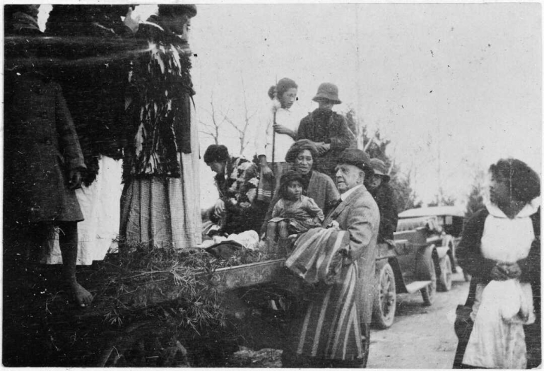 Photograph of Gilbert Mair addressing women and children.