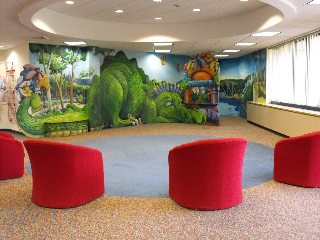 Four red seats in Farmington children's room.