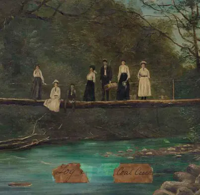 A group of seven men and women on a log bridge.