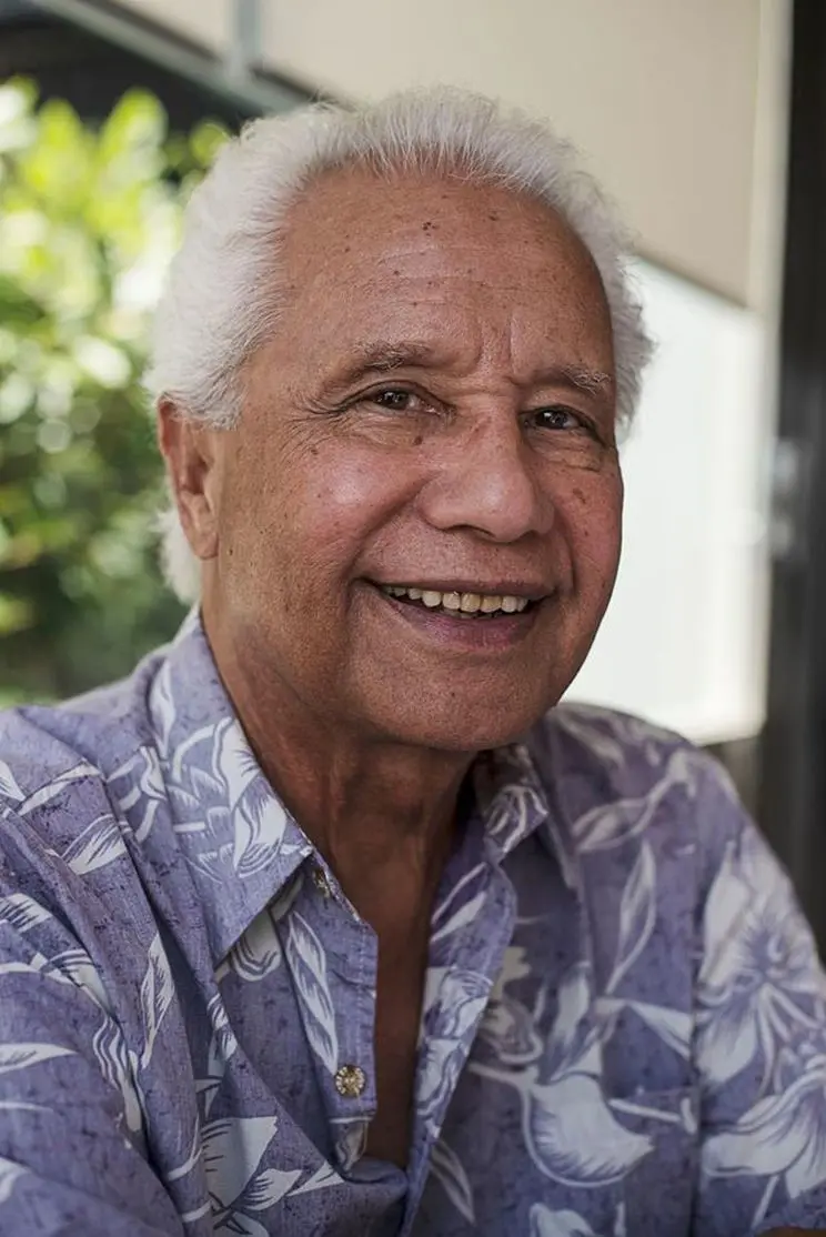 A portrait of a man wearing an Aloha-style shirt.  