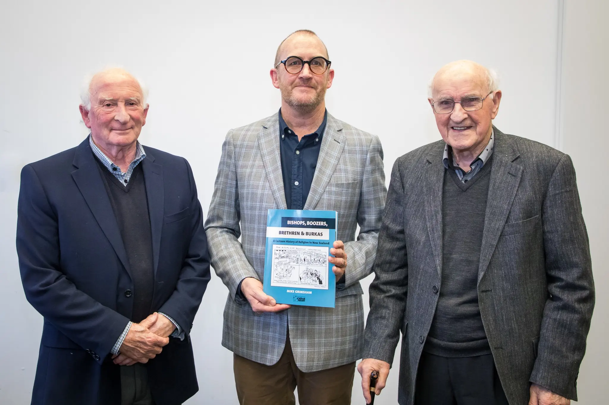 Sir Lloyd Geering (right) with author Mike Grimshaw (centre) and Ian Grant, publisher.