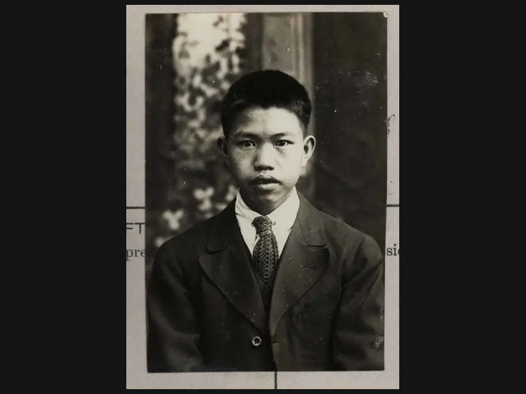 Black and white portrait photo of Chong Ngan in formal clothing.
