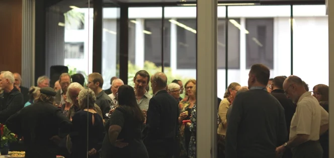 People inside of a room at the 'Good-bye Maoriland' book launch.