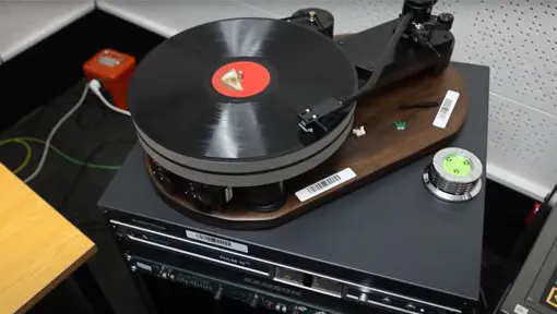 Photo of a record on a record player on a digitisation machine. 