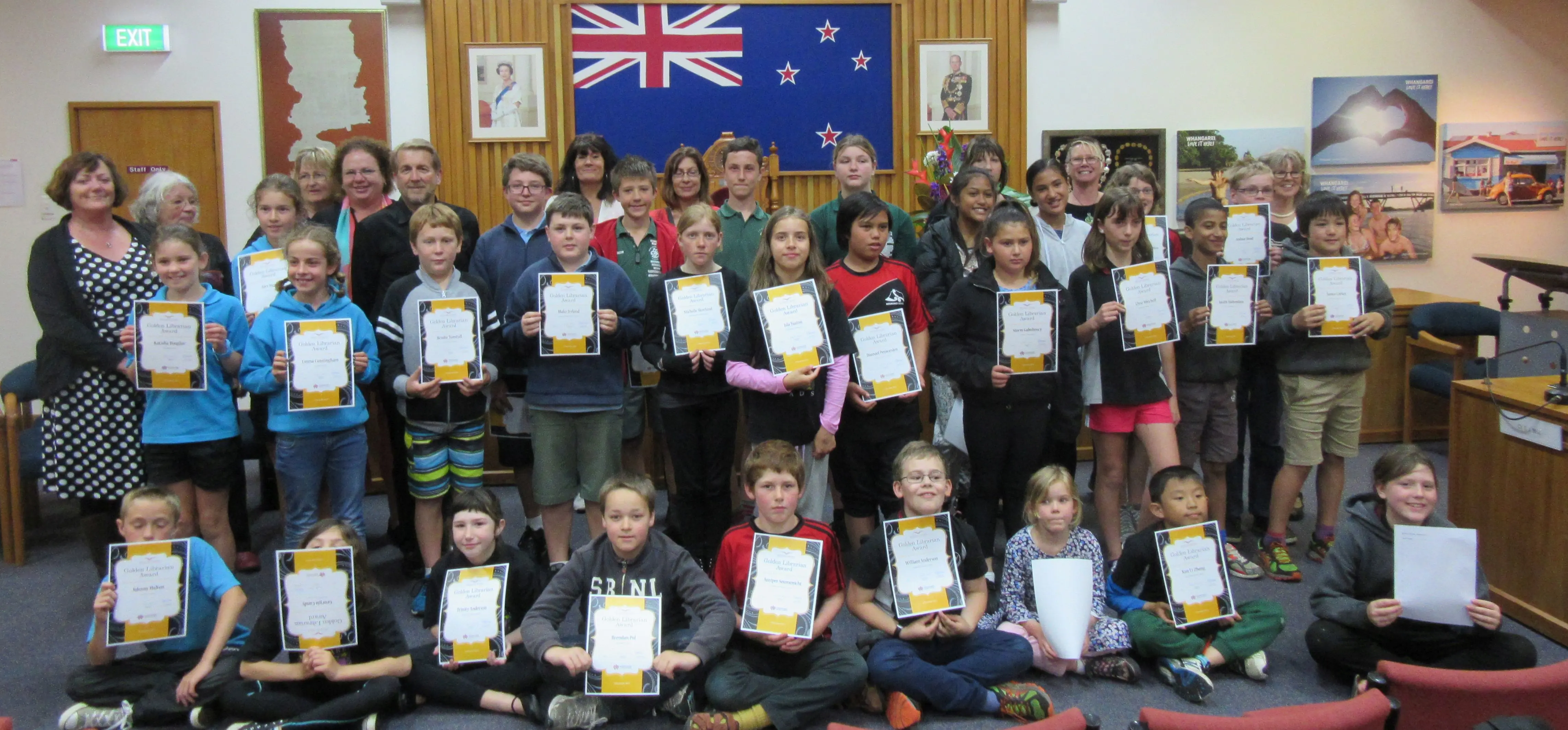 Whangarei schools’ Golden Librarians holding up certificates in the Whangarei Council Chambers.