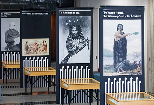 Four hanging banners showing portraits of Sir William Martin, Ereōnora and Panakareao, Te Rangitopeora, and Te Ware Pouri / Te Wharepōuri - Te Āti Awa.