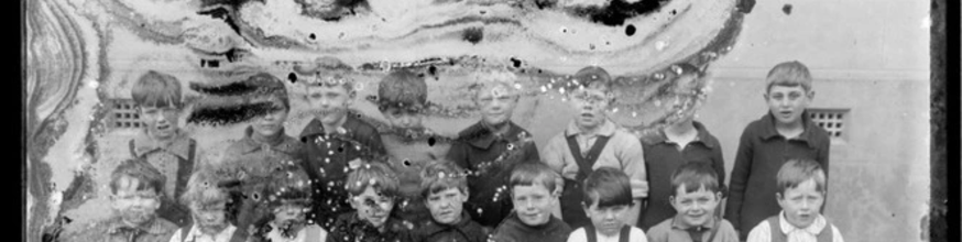 A damaged photograph of a group of children.