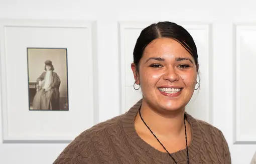 Young Māori woman smiling at camera. 