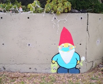 Colourful gnome painted on concrete wall. 