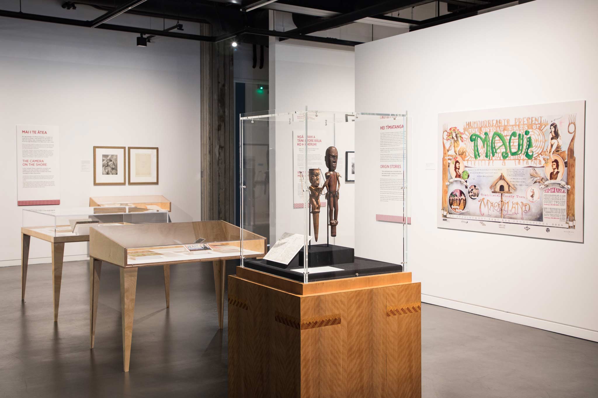 Pūkana exhibition showing exhibition cases and a poster and karetao.